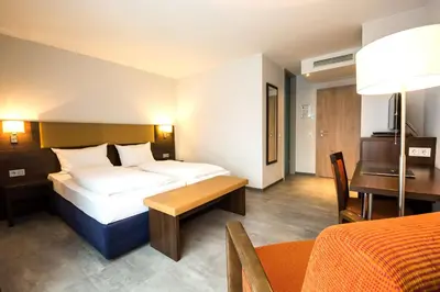 Ein Bett oder Betten in einem Zimmer der Unterkunft domus Hotel