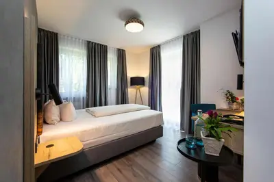 Ein Bett oder Betten in einem Zimmer der Unterkunft Arcus Hotel München Messe