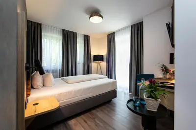 Ein Bett oder Betten in einem Zimmer der Unterkunft Arcus Hotel München Messe