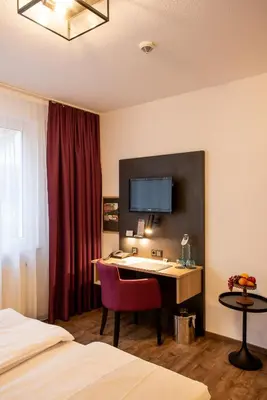 Ein Bett oder Betten in einem Zimmer der Unterkunft Arcus Hotel München Messe