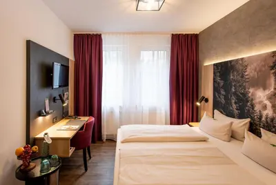 Ein Bett oder Betten in einem Zimmer der Unterkunft Arcus Hotel München Messe