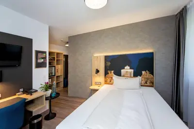Ein Bett oder Betten in einem Zimmer der Unterkunft Arcus Hotel München Messe