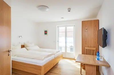 Ein Bett oder Betten in einem Zimmer der Unterkunft Gästehaus Neubauer
