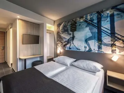 Ein Bett oder Betten in einem Zimmer der Unterkunft B&B Hotel München-Olympiapark