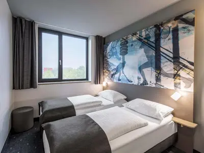 Ein Bett oder Betten in einem Zimmer der Unterkunft B&B Hotel München-Olympiapark