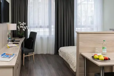 Ein Bett oder Betten in einem Zimmer der Unterkunft AINO Aparthotel Olympiapark