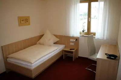 Ein Bett oder Betten in einem Zimmer der Unterkunft Landhotel Winter