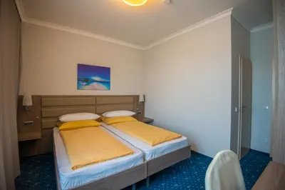 Ein Bett oder Betten in einem Zimmer der Unterkunft Drei Bären Hotel & Apartments