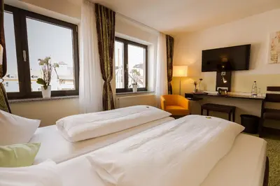 Ein Bett oder Betten in einem Zimmer der Unterkunft Hotel Arooma