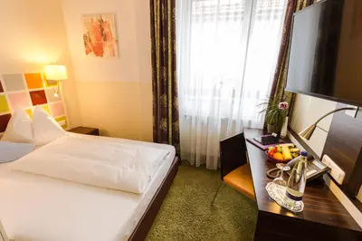 Ein Bett oder Betten in einem Zimmer der Unterkunft Hotel Arooma