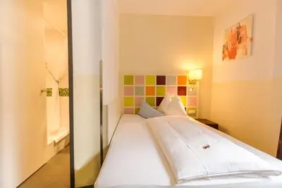 Ein Bett oder Betten in einem Zimmer der Unterkunft Hotel Arooma