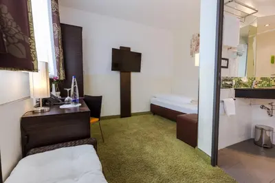 Ein Bett oder Betten in einem Zimmer der Unterkunft Hotel Arooma