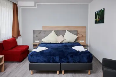 Ein Bett oder Betten in einem Zimmer der Unterkunft Zur Allacher Mühle