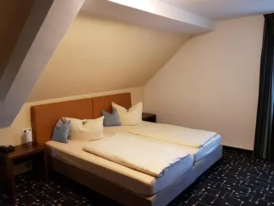 Ein Bett oder Betten in einem Zimmer der Unterkunft Hotel Königer