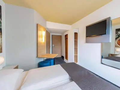 Ein Bett oder Betten in einem Zimmer der Unterkunft B&B Hotel Augsburg-Süd