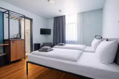 Ein Bett oder Betten in einem Zimmer der Unterkunft Das Schreder Hotel - Munich Free Parking