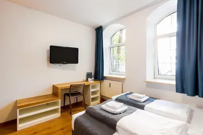 Ein Bett oder Betten in einem Zimmer der Unterkunft mk hotel münchen max-weber-platz