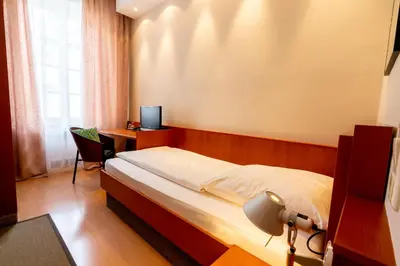 Ein Bett oder Betten in einem Zimmer der Unterkunft Hotel Carlton Munich