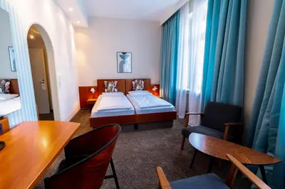 Ein Bett oder Betten in einem Zimmer der Unterkunft Hotel Carlton Munich