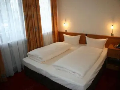 Ein Bett oder Betten in einem Zimmer der Unterkunft Hotel Accolo