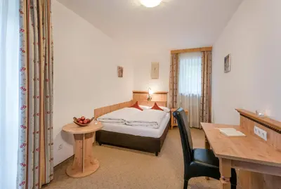 Ein Bett oder Betten in einem Zimmer der Unterkunft Berghaus - Der Westerhof Hotel