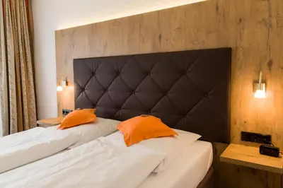 Ein Bett oder Betten in einem Zimmer der Unterkunft Stadthotel Berggeist