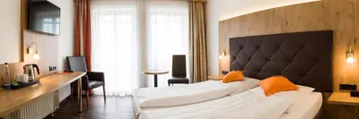 Ein Bett oder Betten in einem Zimmer der Unterkunft Stadthotel Berggeist