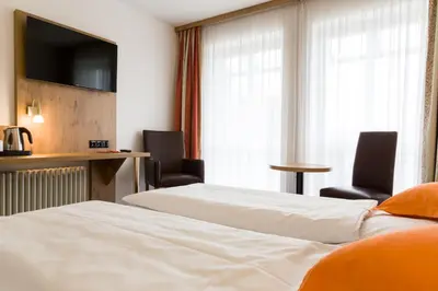 Ein Bett oder Betten in einem Zimmer der Unterkunft Stadthotel Berggeist