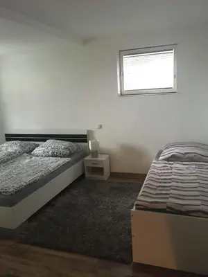 Ein Bett oder Betten in einem Zimmer der Unterkunft L&L Lodge Günding