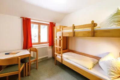 Ein Bett oder Betten in einem Zimmer der Unterkunft Jugendherberge Schliersee