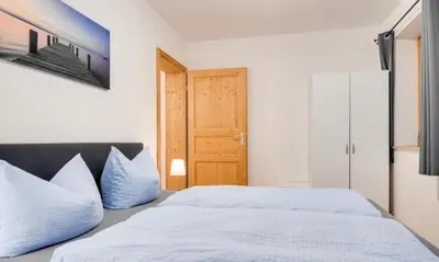 Ein Bett oder Betten in einem Zimmer der Unterkunft Ferienwohnung Bergblick für bis 13 oder 14 Personen mit 5 Schlafzimmer und 3 Bäder