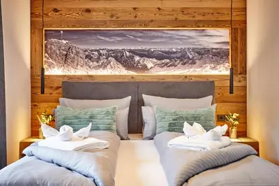 Ein Bett oder Betten in einem Zimmer der Unterkunft Alpis Ferienwohnung