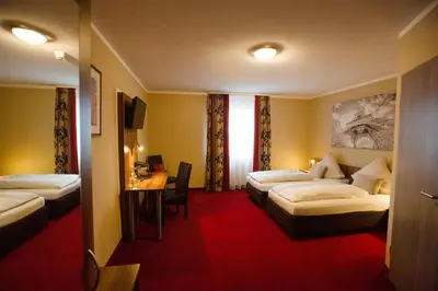 Ein Bett oder Betten in einem Zimmer der Unterkunft Auwald Hotel