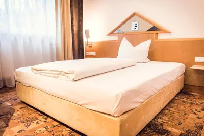 Ein Bett oder Betten in einem Zimmer der Unterkunft Schlosshotel Neufahrn