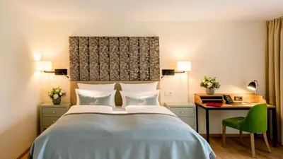 Ein Bett oder Betten in einem Zimmer der Unterkunft Parkhotel Rothof