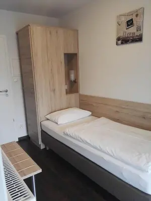 Ein Bett oder Betten in einem Zimmer der Unterkunft Hotel Gasthof Momm