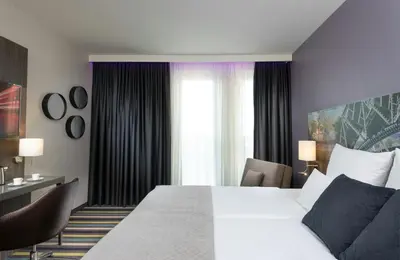 Ein Bett oder Betten in einem Zimmer der Unterkunft Leonardo Hotel Munich City East