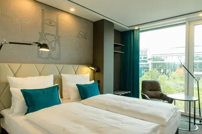 Ein Bett oder Betten in einem Zimmer der Unterkunft Motel One München-Parkstadt Schwabing