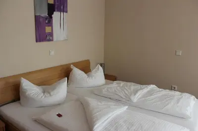 Ein Bett oder Betten in einem Zimmer der Unterkunft Hotel Alex