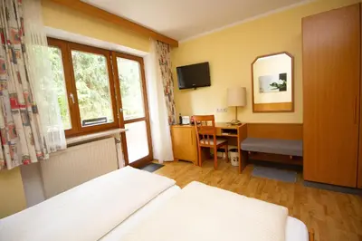Ein Bett oder Betten in einem Zimmer der Unterkunft Hotel am Wald