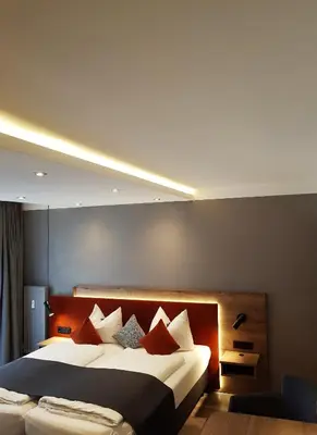 Ein Bett oder Betten in einem Zimmer der Unterkunft Apparthotel Garni Superior Simsseeblick