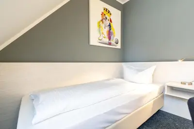 Ein Bett oder Betten in einem Zimmer der Unterkunft Hotel Wandinger Hof