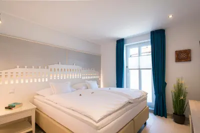 Ein Bett oder Betten in einem Zimmer der Unterkunft Chiemsee Suiten