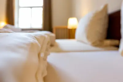 Ein Bett oder Betten in einem Zimmer der Unterkunft Hotel Schyrenhof