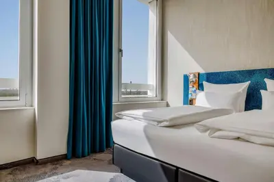 Ein Bett oder Betten in einem Zimmer der Unterkunft Motel One München-Campus