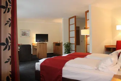 Ein Bett oder Betten in einem Zimmer der Unterkunft Ambassador Apparthotel