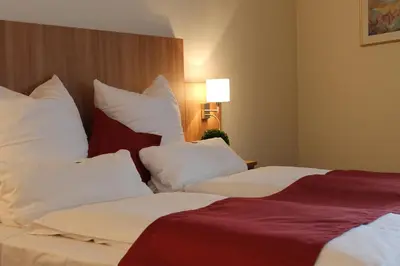 Ein Bett oder Betten in einem Zimmer der Unterkunft Ambassador Apparthotel
