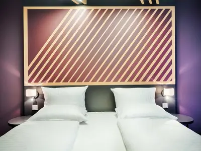 Ein Bett oder Betten in einem Zimmer der Unterkunft B&B Hotel München-Moosach
