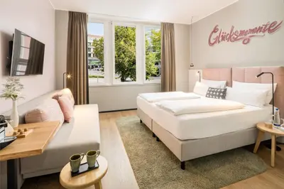 Ein Bett oder Betten in einem Zimmer der Unterkunft KOOS Hotel&Apartments - City Aparthotel