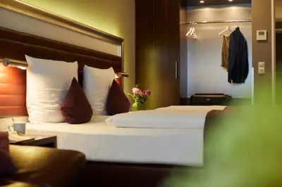Ein Bett oder Betten in einem Zimmer der Unterkunft Hotel Metropol by Maier Privathotels